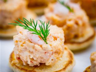 seafood with rosemary sprig on bread round